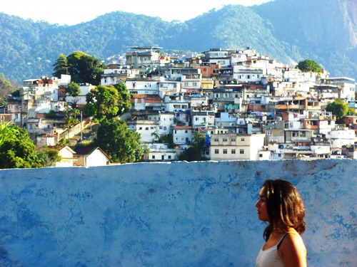 A favela hill town in Rio de Janeiro, Mayra walking in front.