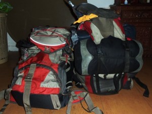 Two hitchikers' backpacks ready to go.
